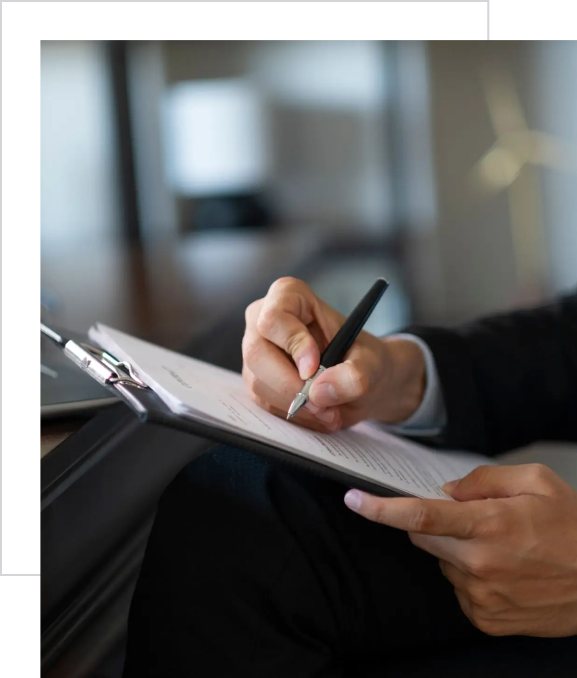 Man holding pen and clipboard